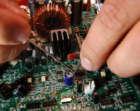 Technician repairing motherboard